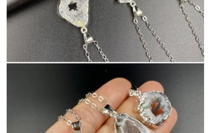 Close-up of natural druzy agate pendant with silver edging and delicate metal chain