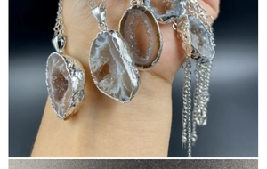 Detailed view of assorted natural agate geodes with silver plating on delicate chains