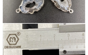 Detail of natural blue agate geode pendant with silver edges and 26mm measurement