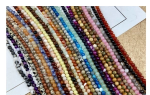 Detailed close-up of mixed natural 4mm gemstones beads for DIY jewelry making