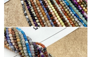 Close-up of 4mm natural round gemstone beads including agate and tiger eye for DIY jewelry