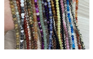 Close-up of 4mm polished natural gemstone beads including amethyst and agate for jewelry making