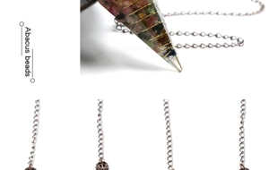 Close-up of hexagonal crystal pendulum with colorful stones and vintage metal chain
