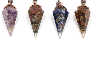 Detail of four hexagonal resin crystal pendants with gold wire and vintage copper caps