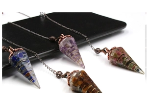 Detailed macro view of resin cone pendants with crushed crystals and golden wire wrap