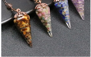 Detailed close-up of resin hexagonal pendants with natural crushed crystals and wire wrap