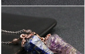 Close-up of resin cone pendants with natural crystals and wire wrap detail on chains