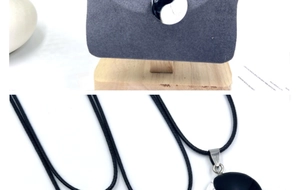 Detail of the yin yang tai chi pendant with classic black and white stones on a rope cord