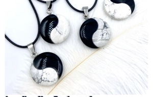 Detail of Tai Chi Yin Yang stone pendants with white turquoise marble texture and cord