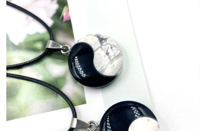 Detail of Yin Yang pendants crafted from black agate and white marble stone with cord