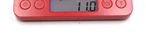 Close-up of a digital kitchen scale showing buttons and weight measurement on LCD