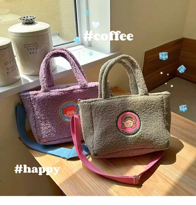 Detail of purple and green plush tote bag with cartoon patches and colorful strap