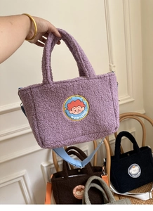 Detail of soft purple lamb wool tote bag with cartoon embroidery and blue strap