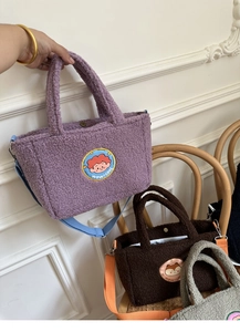 Detailed macro view of plush lamb wool tote bags in purple, brown and grey colors