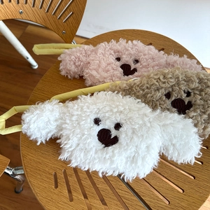 Detail view of plush teddy bear coin purses in white, pink and brown with fluffy texture