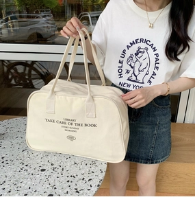 Close-up of large canvas Boston travel bag with vintage lettering and sturdy handles
