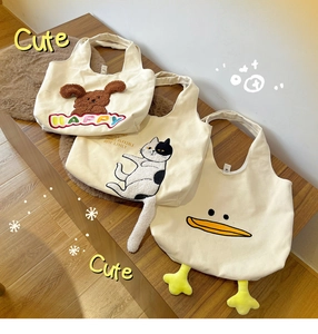Detail of cute canvas tote bags with 3D animal designs including cat and duck patterns