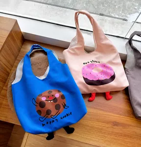 Close-up of cute cartoon canvas tote bags with 3D feet design in pink and blue colors