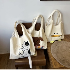 Three cute animal canvas bags with 3D plush ears and tails on a vintage brown chair