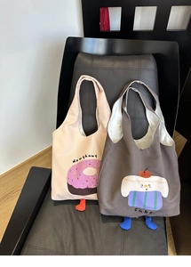 Close-up of canvas bags with cute doughnut and cake prints and 3D plush feet detail