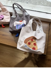 Close-up of creative canvas tote bags featuring 3D plush legs and cute snack illustrations