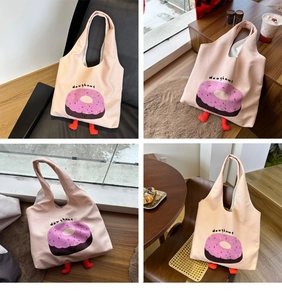 Pink canvas tote bag with doughnut print and unique decorative red legs on bottom