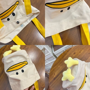 Detail of cute canvas tote with cartoon duck embroidery, star charms and metal snap button