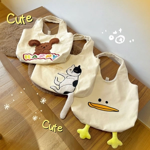 Cute canvas tote bags with 3D plush animal designs on a cozy wooden bench background