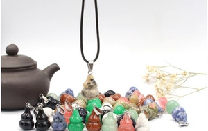 Detail of natural gemstone Wu Lou pendants in various crystals with black cord necklace