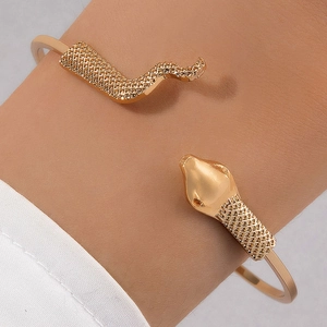 Golden snake-shaped open bracelet featuring detailed grid scales and polished metal finish