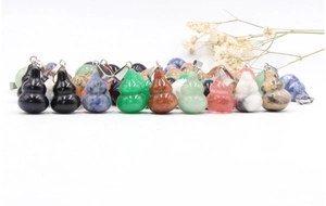Macro shot of assorted natural gemstone gourd pendants with silver metal clasps