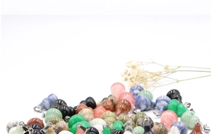Close-up of assorted natural gemstone gourd pendants with silver metal clasps