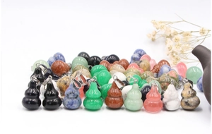 Detailed close-up of colorful gourd pendants in obsidian, lapis lazuli and natural stones