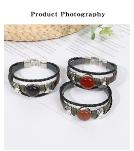 Detailed view of bohemian braided leather bracelets with agate stones and metal charms