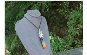 Detailed view of chakra hexagonal pillar pendant with colorful natural stones on mannequin
