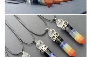 Macro view of seven chakra hexagonal crystal pillar pendant with silver clasp and cord