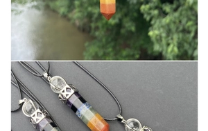 Macro detail of hexagonal 7 chakra healing crystal pendant with silver ornate clasp