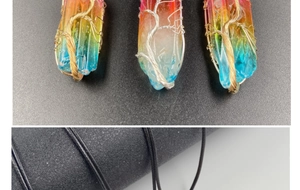 Détail de pendentifs en quartz cristal avec fil métallique et motif arbre de vie