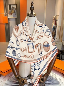 Detailed view of the equestrian pattern scarf displayed on a white fashion mannequin