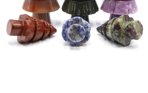 Macro detail of various natural gemstone carvings including mushroom and spiral shapes