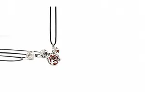 Detail of tree of life locket necklace with natural stones on a simple black cord