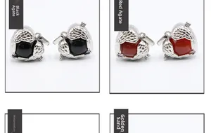Detail view of angel wing lockets with black, red, pink, and goldstone spheres