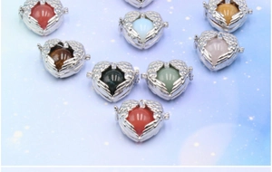 Detail showing heart-shaped angel wing pendants with various colorful gemstone beads