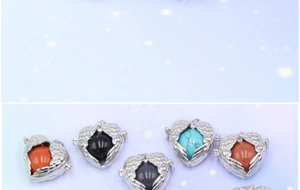 Detail of angel wing heart locket pendants with various colored gemstone beads
