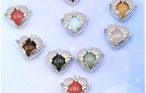 Detail of angel wing heart locket pendants with assorted colorful gemstone orbs