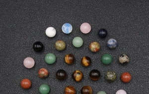 Close-up of polished 10mm non-porous natural stone beads including aventurine and tiger eye