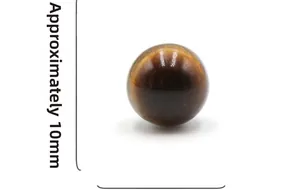 Macro shot showing a 10mm tiger eye gemstone bead with golden brown texture