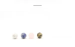 Detailed display of four 10mm round natural and synthetic stone beads in various colors