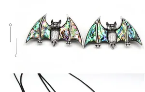 Close-up of gothic bat pendant necklace with colorful iridescent abalone shell wings