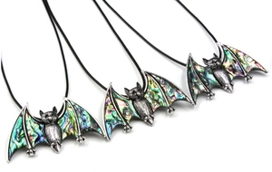 Detailed view of bat pendants featuring colorful abalone shell inlays on black cords